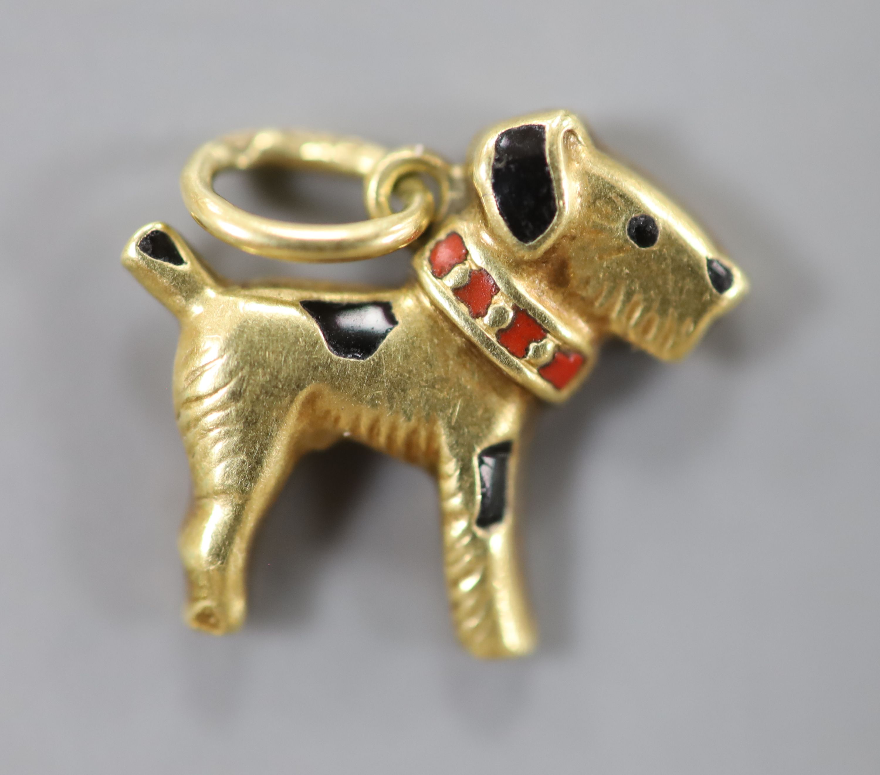 A modern 585 yellow metal and two colour enamel set Scottie dog pendant, 12mm, gross 0.8 grams.